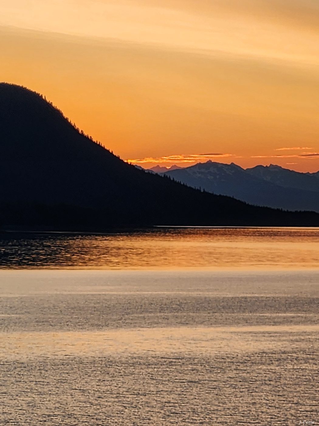 Alaska Golden Hour — warm golden light over Inside Passage at sunset, color photography by Jon Canis