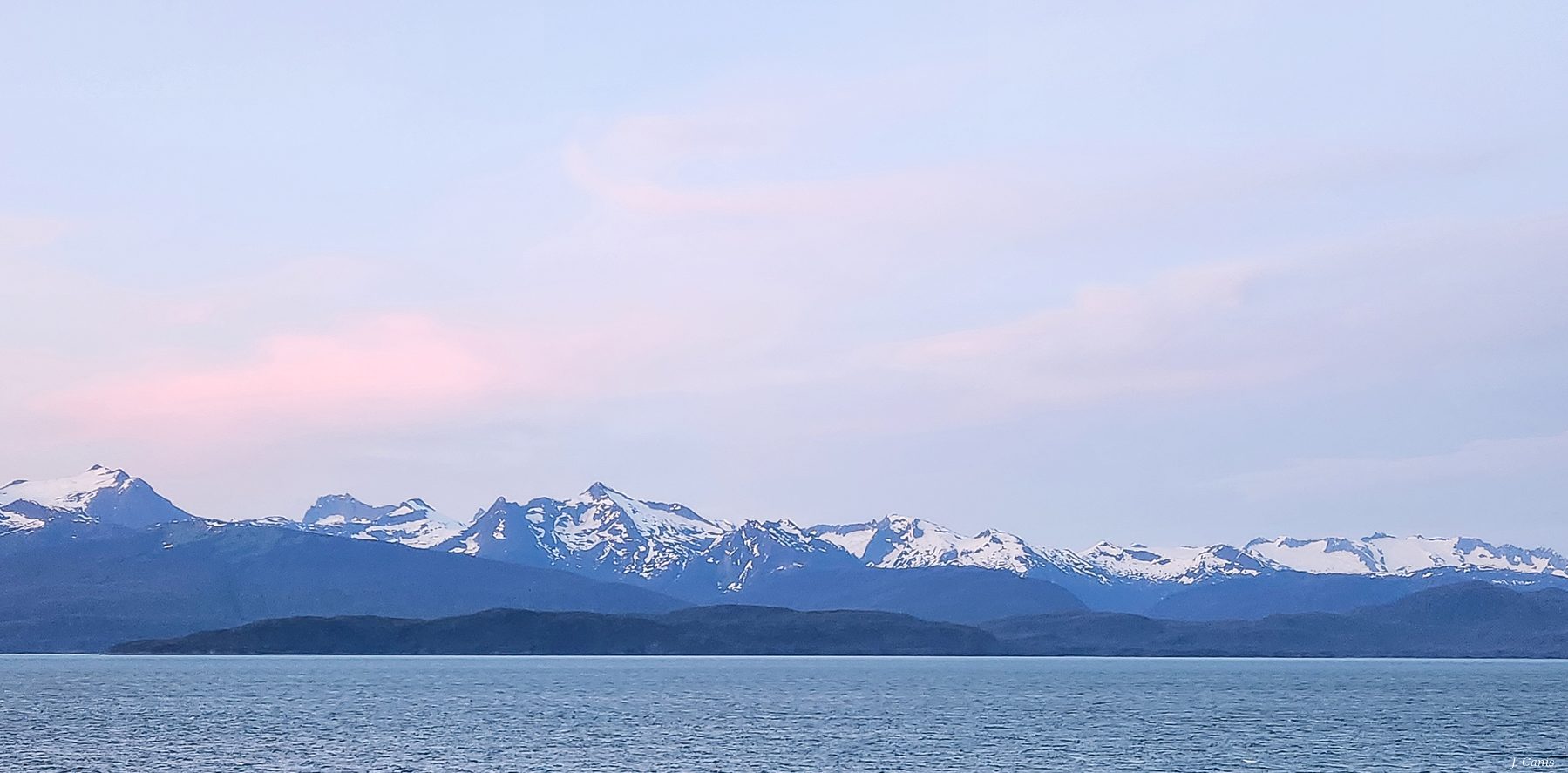 Alaska Alpenglow — pastel alpenglow over snow-capped Inside Passage peaks at dusk, color photography by Jon Canis