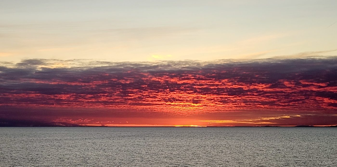 Alaska Sunrise — crimson and orange dawn sky over Inside Passage waters, Alaska morning photography by Jon Canis