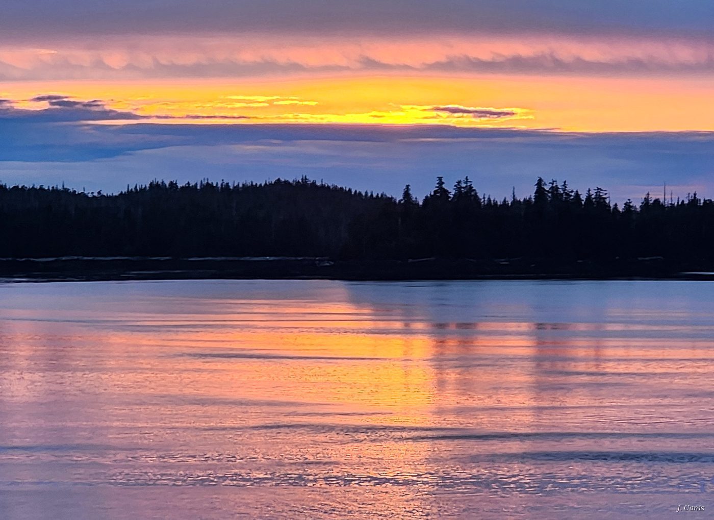 Alaska Twilight — lavender and orange twilight at midnight over Inside Passage treeline, color photography by Jon Canis