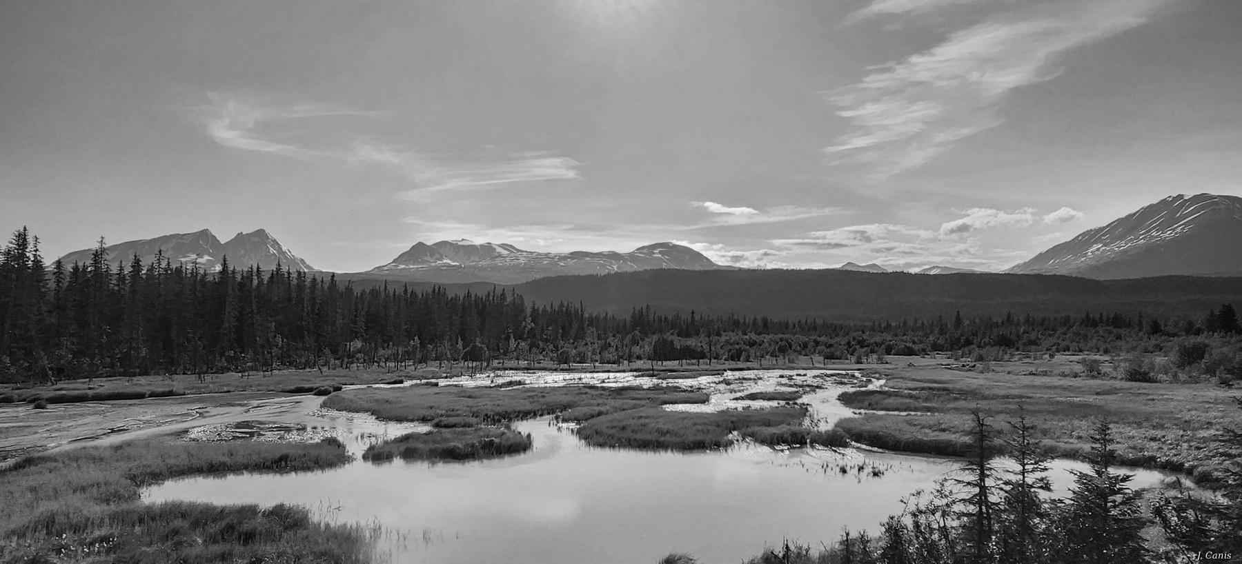 Alaska Wetlands — tidal wetlands reflecting mountains under sweeping Alaska sky, black and white photography by Jon Canis