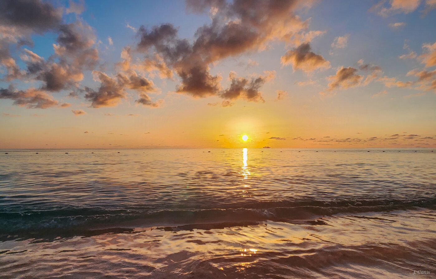 Seven Mile Sunset — sun setting over Seven Mile Beach Cayman Islands, photography by Jon Canis