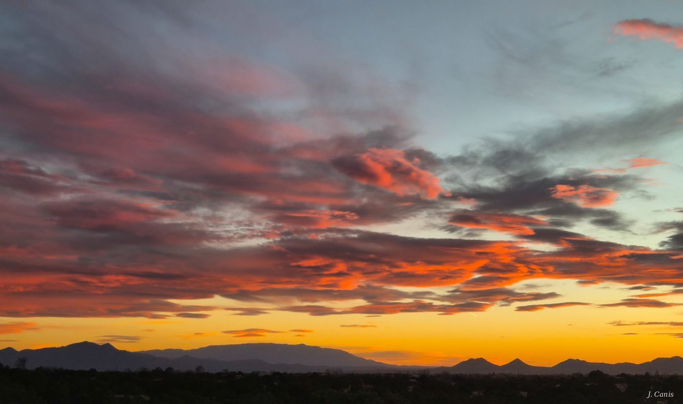 Santa Fe Afterglow — salmon and orange afterglow clouds over Santa Fe mountain silhouette, Southwest photography by Jon Canis